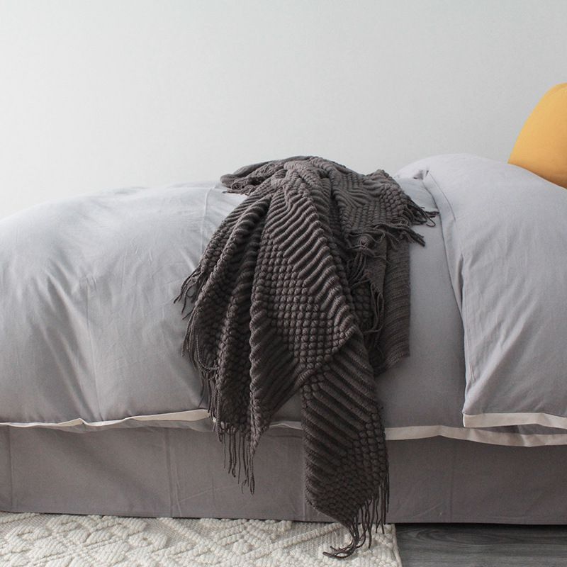 Knitted blanket in gray tones