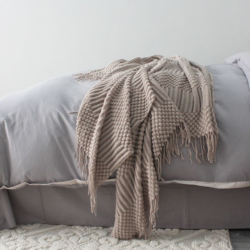 Knitted blanket in gray tones