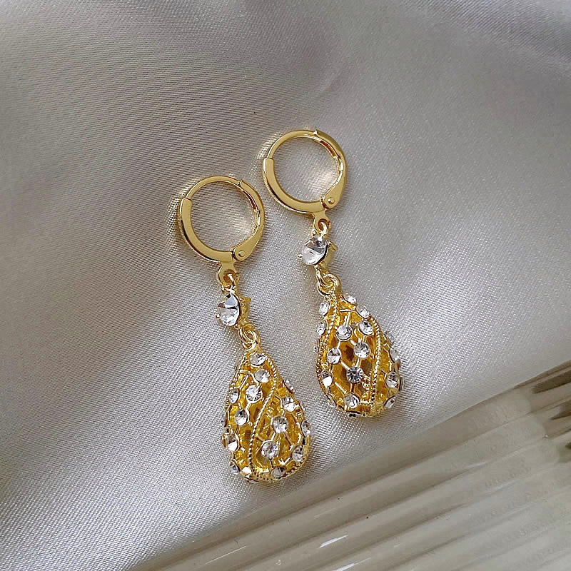 Zircon inlaid carved water drop earrings